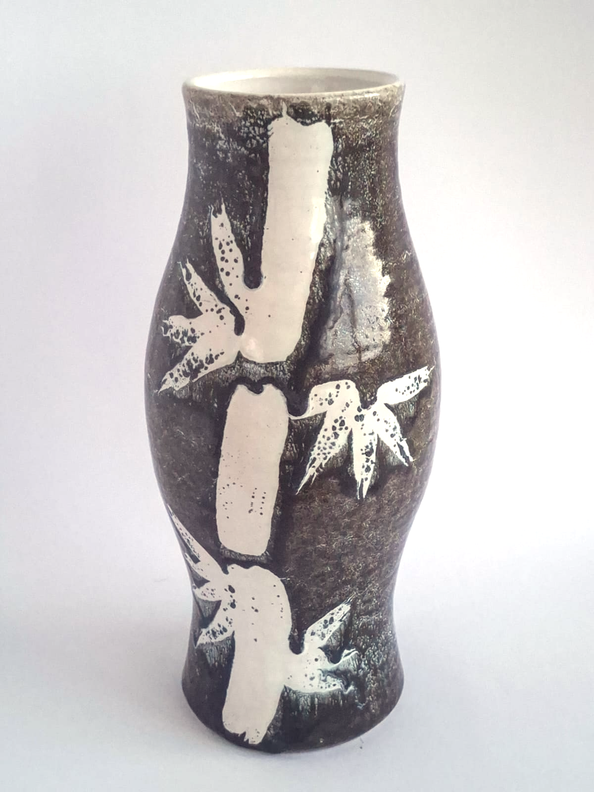 Black vase with bamboo and swallows