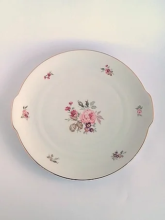 Cream porcelain serving platter with beige and pink floral sprays and gold trim, matching the soup terrine