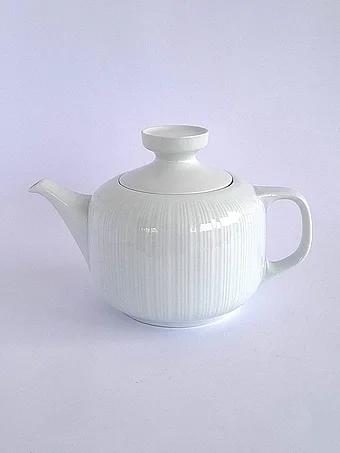 Modern white porcelain teapot with clean ribbed texture and minimalist design