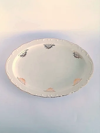 White oval serving platter with scalloped edge, sparse gold lattice motifs, and gold rim