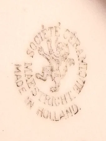 Brown stamped circular mark featuring the Limburg lion rampant, reading SOCIÉTÉ CÉRAMIQUE MAASTRICHT MADE IN HOLLAND