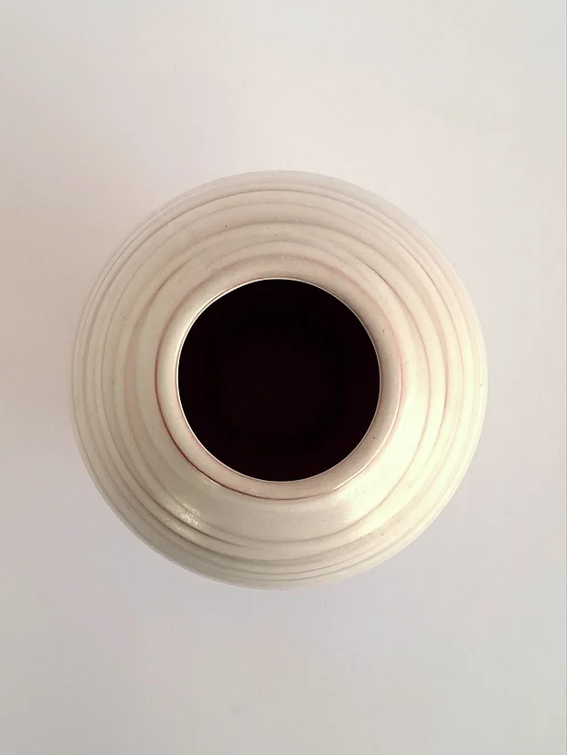 Top view looking down into the vase opening, showing concentric ribbed texture and dark glazed interior